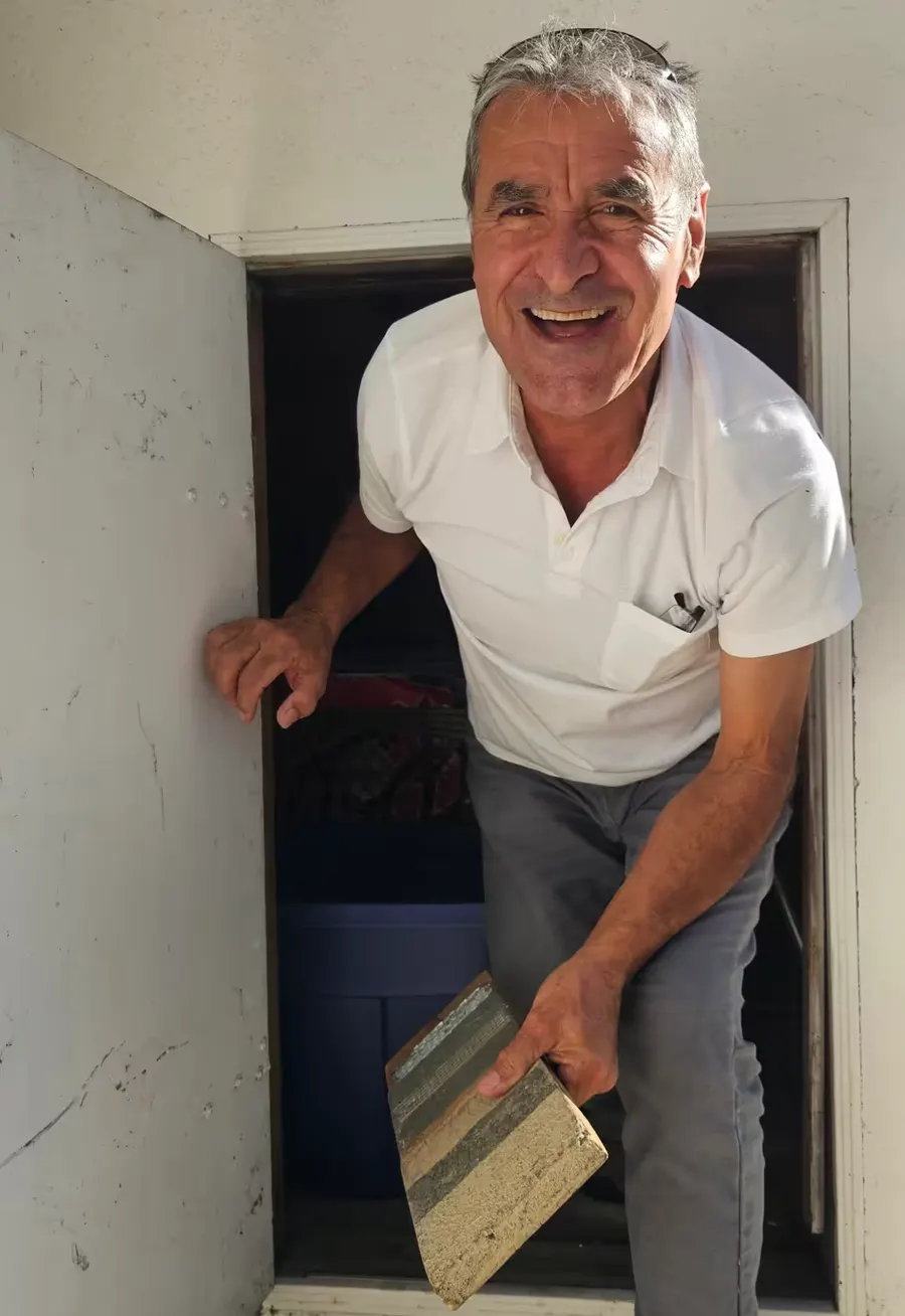 CBS craftsman holding a layered deck coating sample